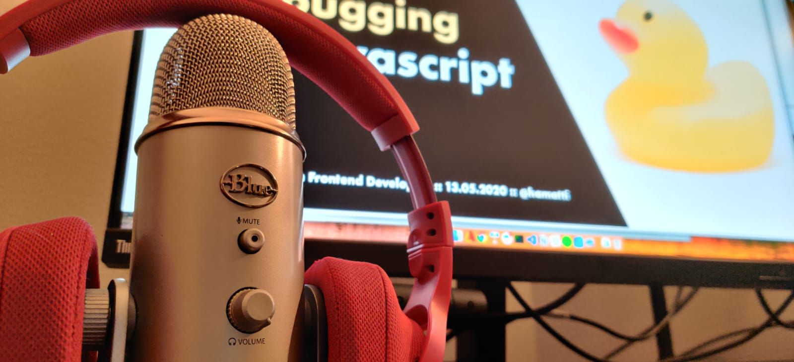 a podcast microphone with headphones resting on top of it