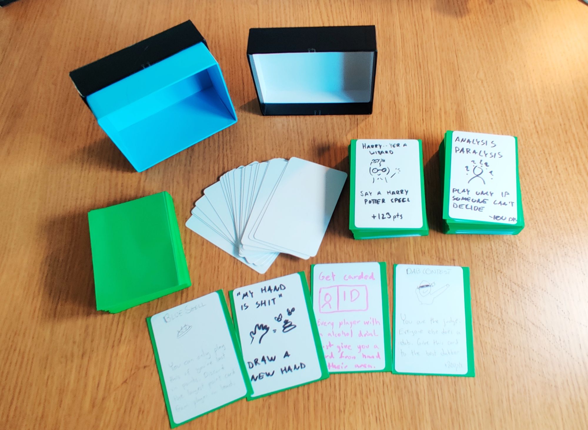A collection of empty green sleeves, empty cards and two stacks of cards with handwritten text and pictures