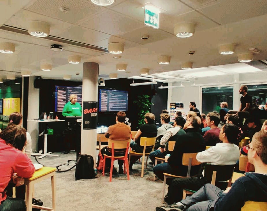 A group of people sitting in the audience, watching me give a talk in an office