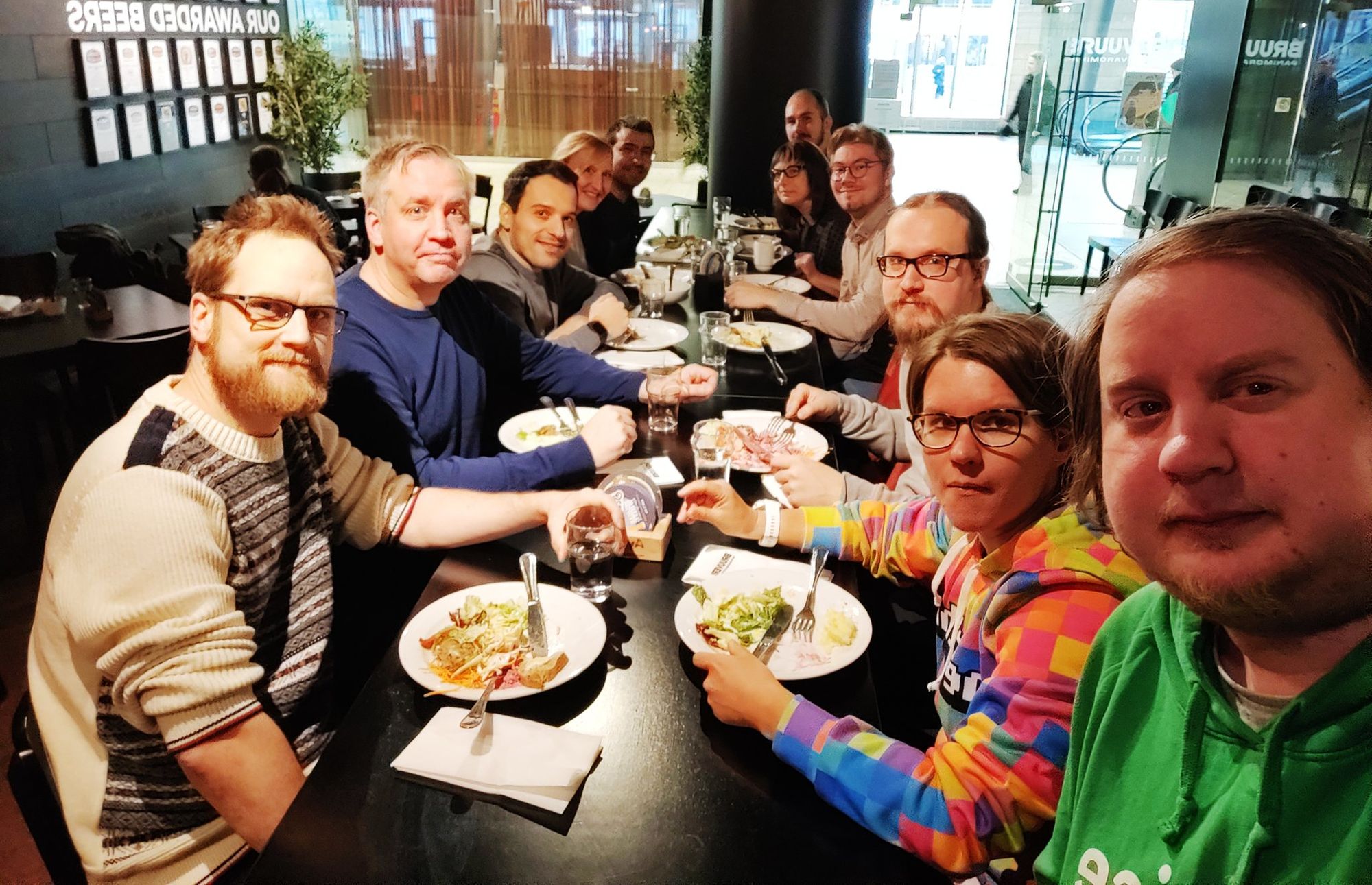 A group of people eating lunch on a long table