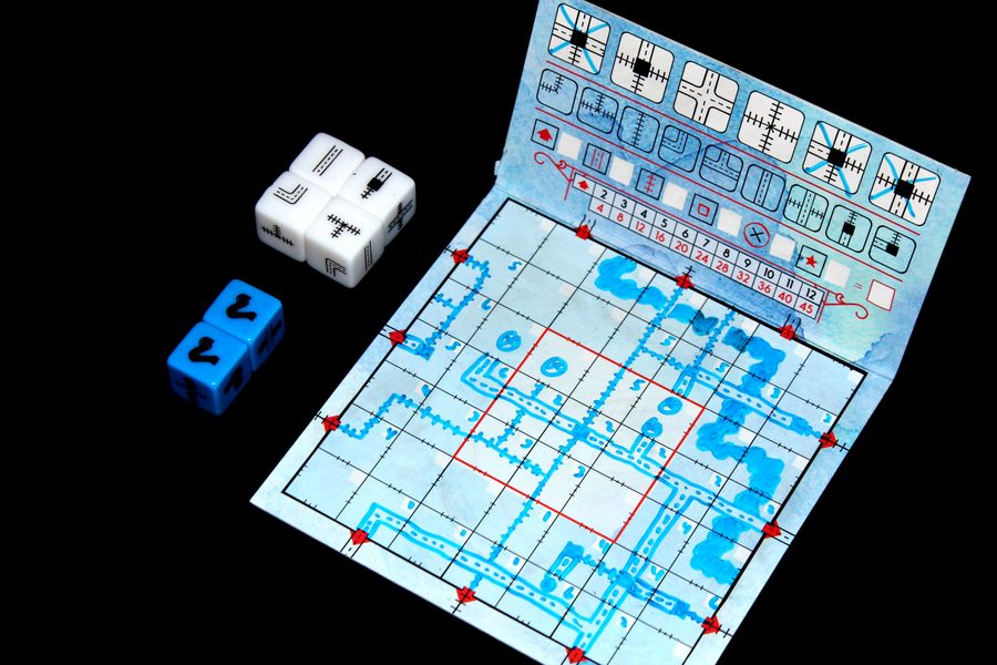 A 7-by-7 square board with a network of highways and railroads drawn by blue marker.