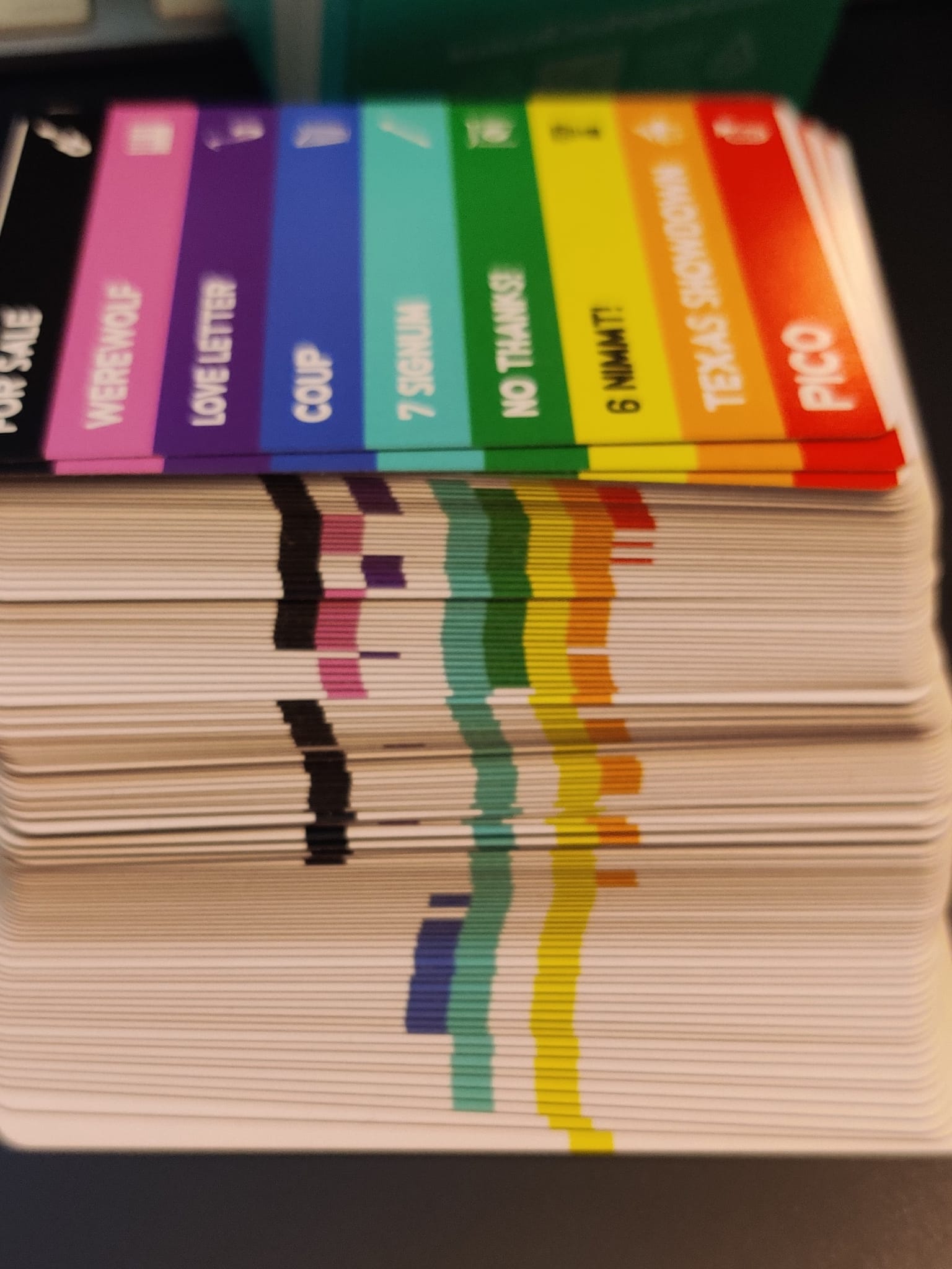 A deck of white cards with varied colored stripes on the side.