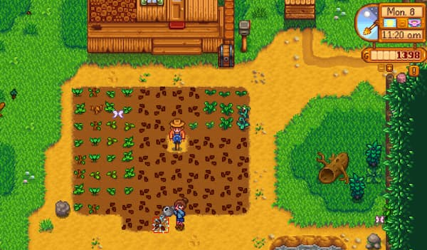 A screenshot of Stardew Valley farm where farmer is watering her crops