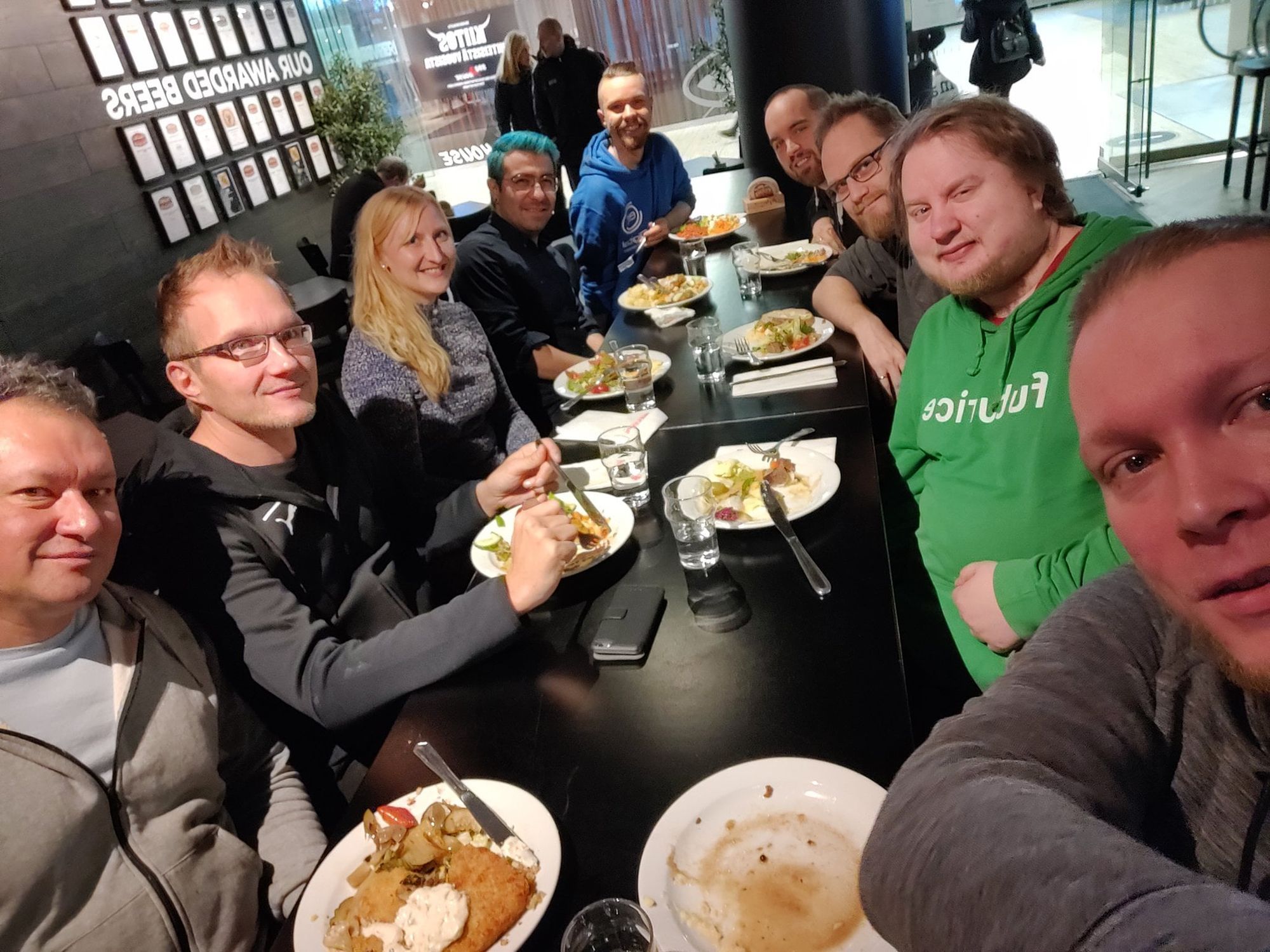 A group of developers eating lunch around a long table