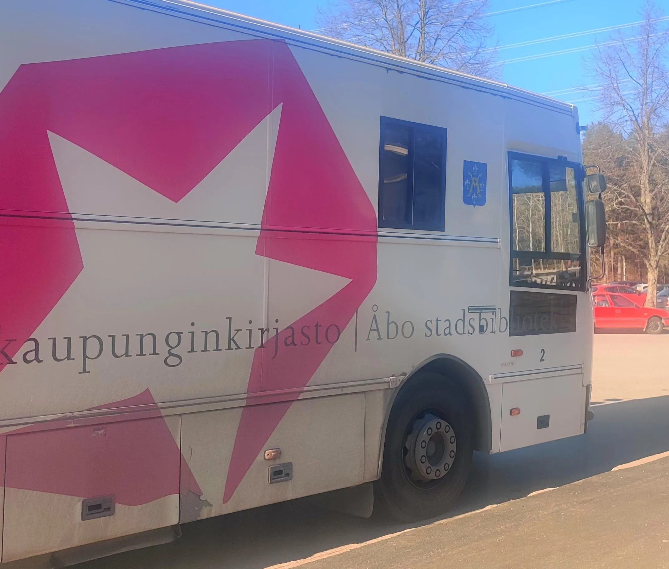 A library bus on a sunny early spring afternoon parked on a parking lot. 