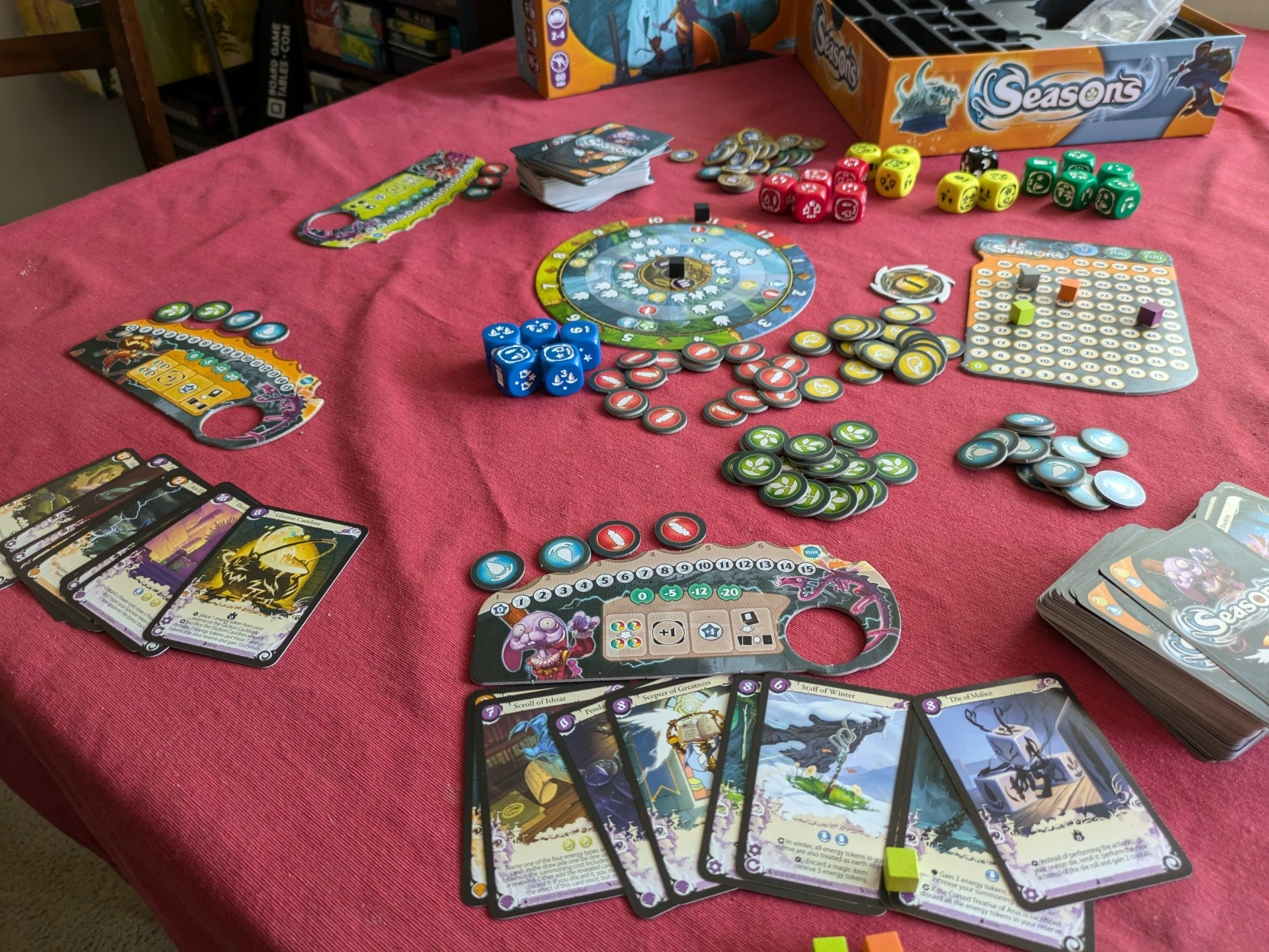 On-going game four player game of Seasons with a variety of cards played and energy tokens collected. 