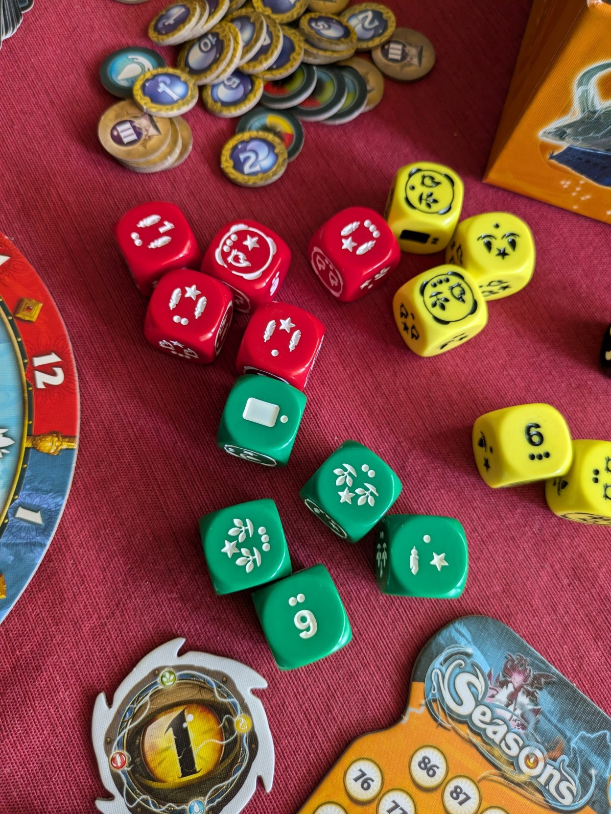 Close up of Seasons’ red, green and yellow dice 