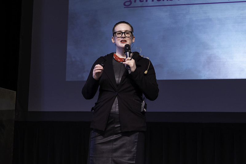 Rachel speaking on a stage 