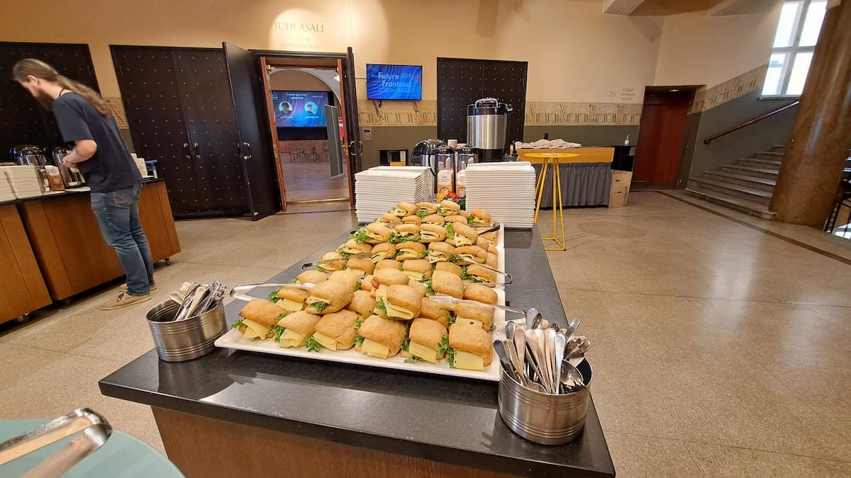 A tray of delicious looking cheese sandwiches in a lobby of a conference center 