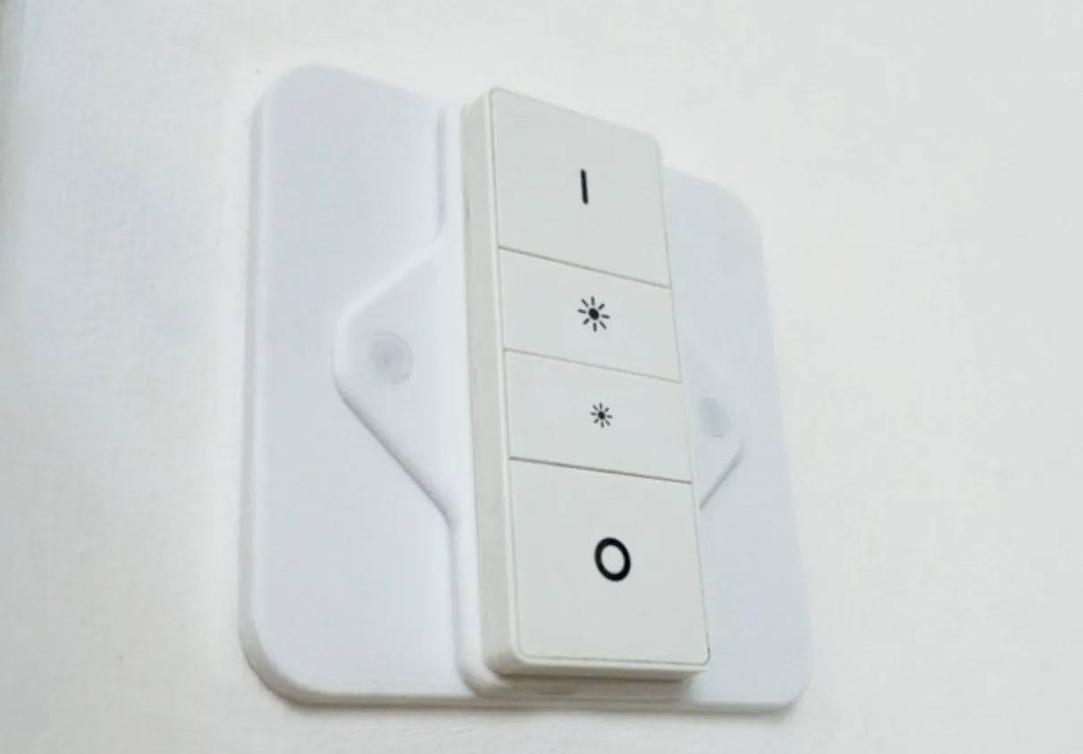 A white light switch with four buttons: on, brightness up, brightness down, off. 