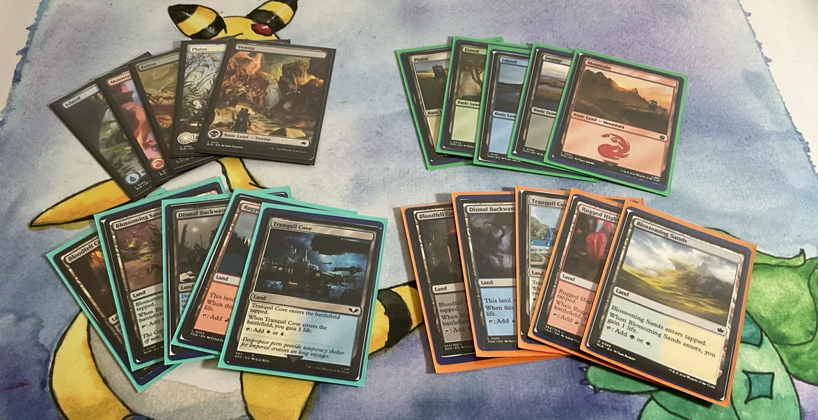 Four fanned out piles of five Magic the Gathering lands. 
