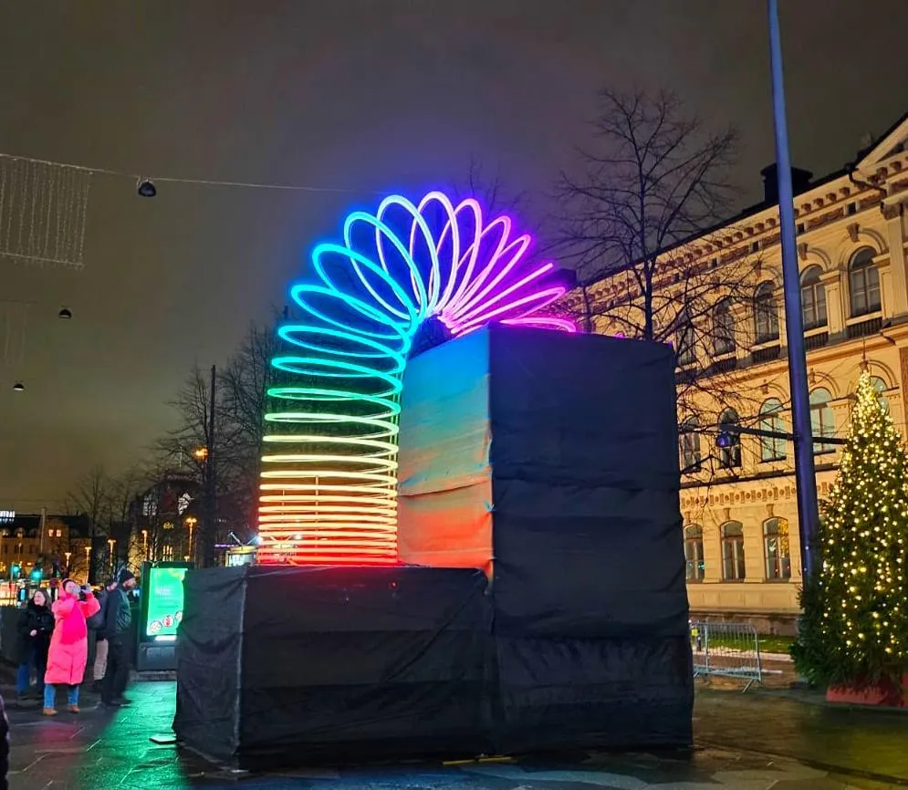 A rainbow coloured massive Slinky in the darkness of Finnish winter in January. 